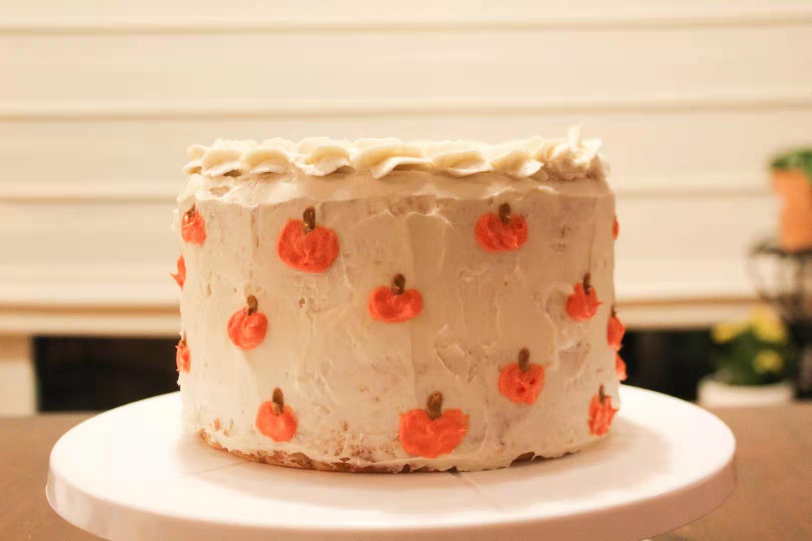 a picture of a cake decorated with white frosting and little pumpkins